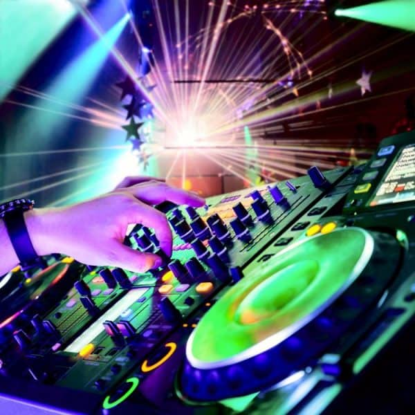 Dj mixes the track in the nightclub at party